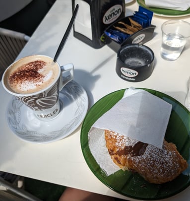 Il Giardino Mediterraneo breakfast, cappuccino with a chocolate-filled croissant.