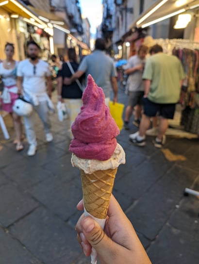 Raki gelato in a cone, hazelnut on the bottom, pomegranate on top. Picture taken in front of the Via S. Cesareo location