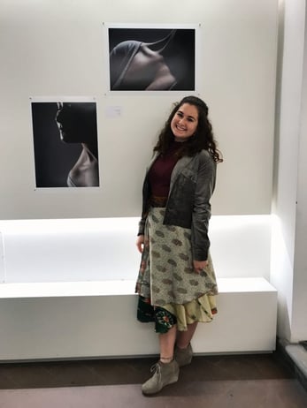 FA18_Semester-in-Florence-Florence-University-of-the-Arts_Rachel-Zuckerberg_Columbia-College-Chicago_posed-next-to-her-photography-in-student-museum fashion and photography abroad