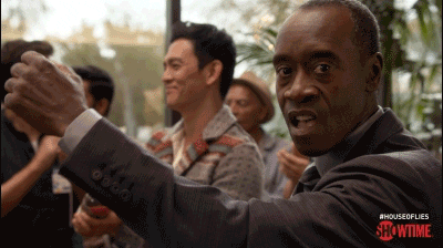 Don Cheadle fist pumping with dollar signs gif